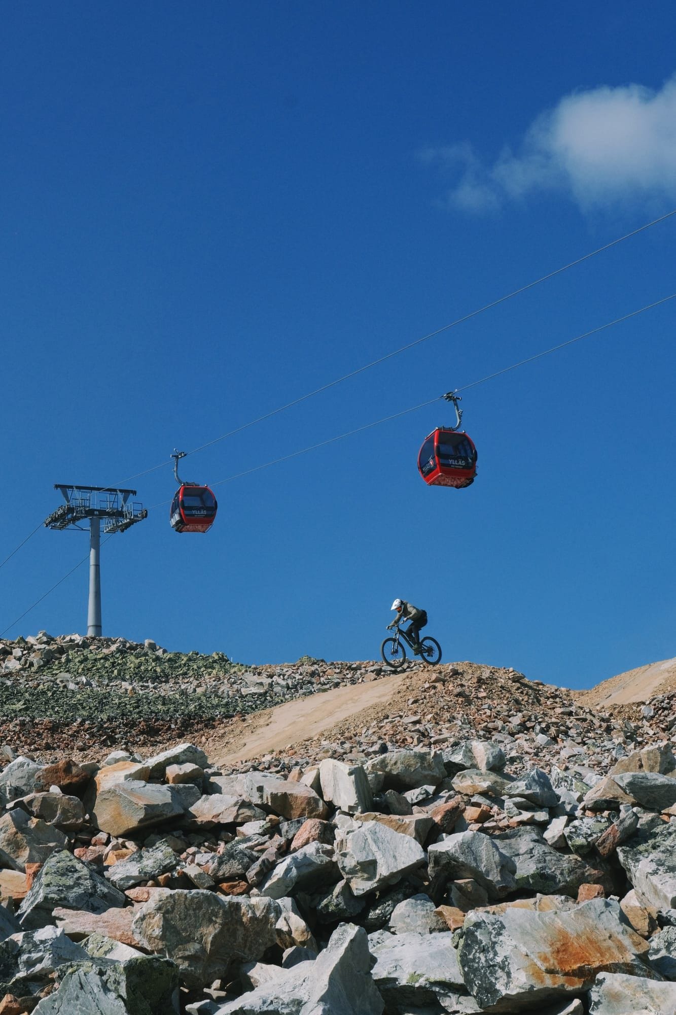 Mountain biker hitting a drop on the 95980 Murica trail at Ylläs