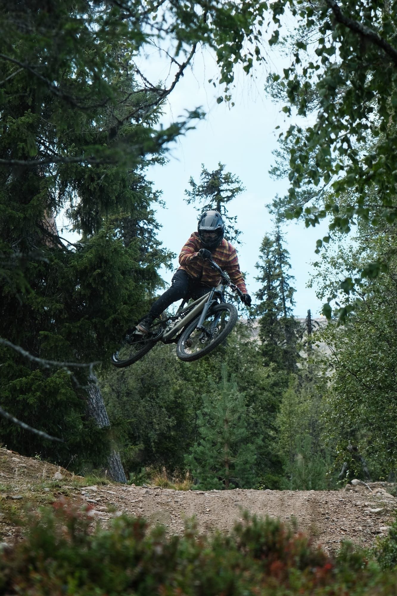 Biker carving a steep berm on the 95980 Murica trail at Ylläs Bike Park