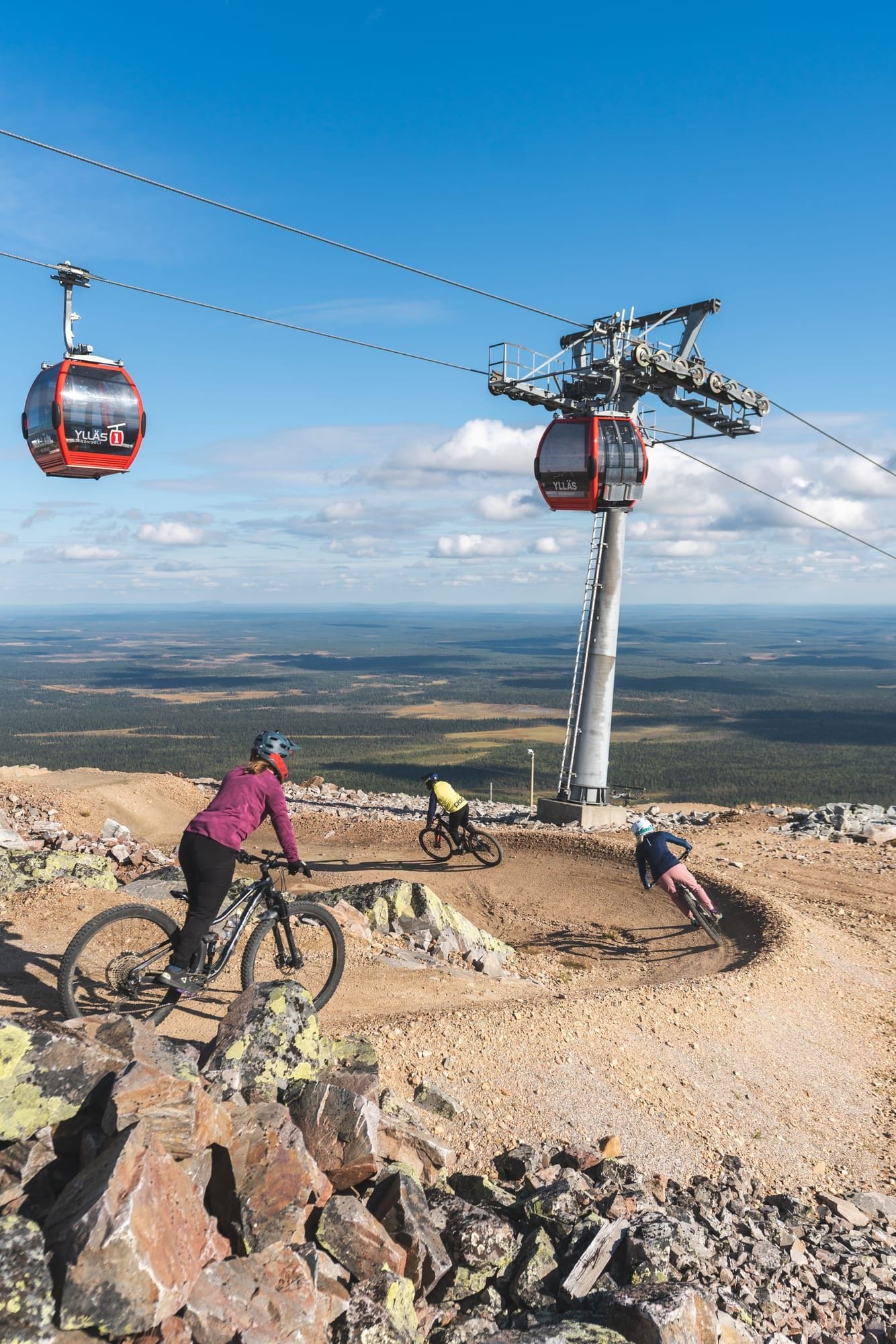 Rider clearing the rock gap jump on the 95980 Murica trail at Ylläs