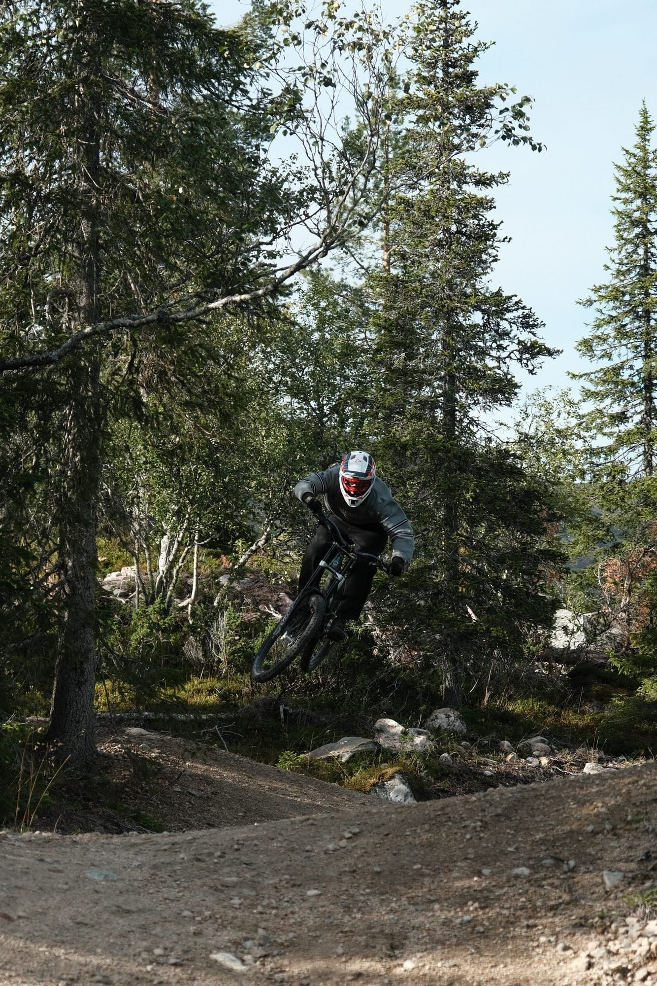 Mountain biker launching a tabletop jump on the Air Flow trail at Ylläs Bike Park