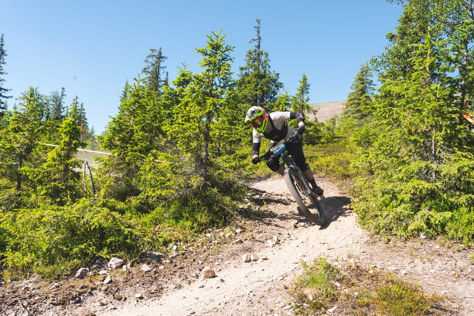 Mountain biker clearing loose rocks on the Enduro Twist trail at Ylläs