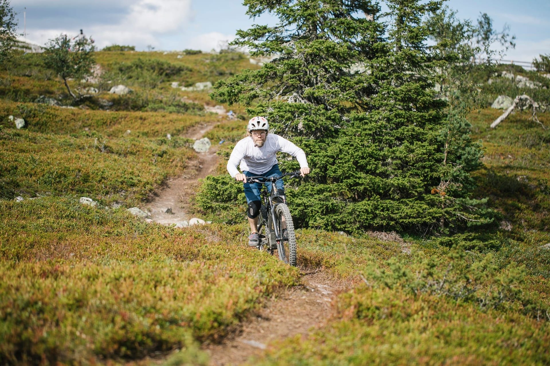 Maastopyöräilijä juurakkoisessa maastossa Full Enduro -reitillä Ylläksellä