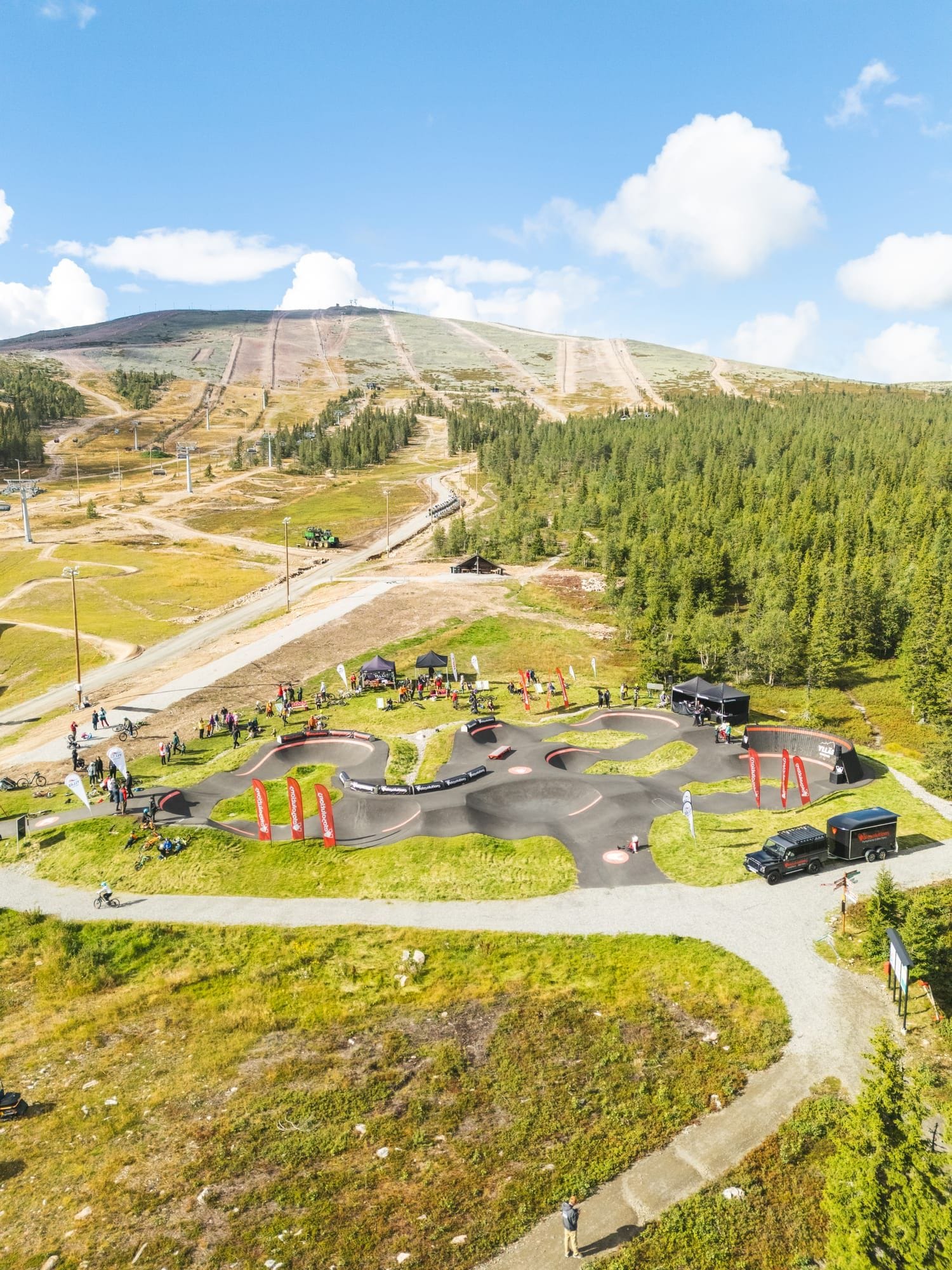 Rider pumping rollers on the Ylläs Bike Park pump track