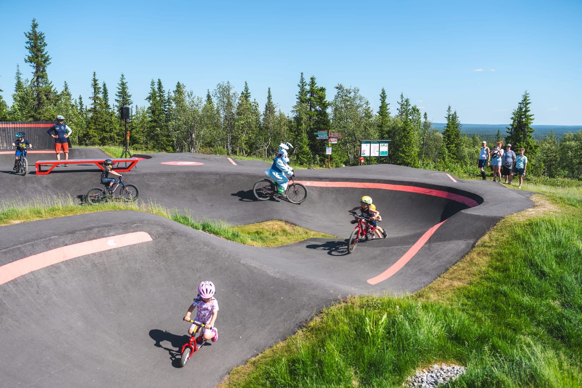 Mountain biker gaining speed by pumping rollers at Ylläs Bike Park